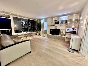 a living room with a couch and a television at Eiffel Tower spacious 2-bedroom, 2-bathroom quiet apartment, elegant and peaceful in Paris
