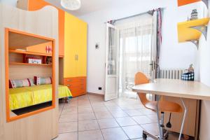 a bedroom with a bed and a desk and a table at Casa Kanustera in Ischia