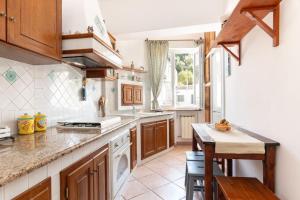 a kitchen with wooden cabinets and a counter top at Casa Kanustera in Ischia