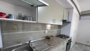 a kitchen with a sink and a counter top at Diamant ikbel in Harqalah