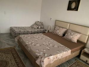 a bedroom with a bed and a chair at Diamant ikbel in Harqalah +4 photos