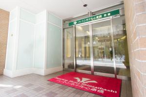 a red rug in front of a store front at Hearton Hotel Shinsaibashi in Osaka