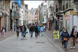 a group of people walking down a city street at Appartement typique Gare Lille Flandre centre ville in Lille