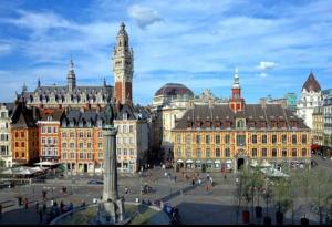 a city with a clock tower and a large building at Appartement typique Gare Lille Flandre centre ville in Lille