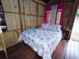 a bedroom with a bed in a wooden room at La cabaña de Eugenio in Convento