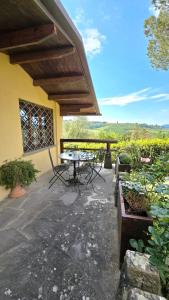 a patio with a table and chairs in front of a building at Amore in Chianti in Greve in Chianti