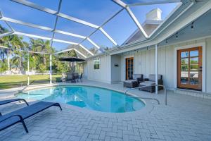 a swimming pool with a glass roof at Naples Duplex Home with Private Pool and Lanai! in Naples