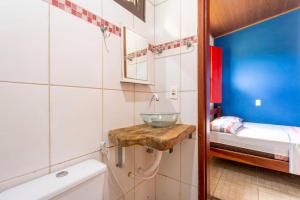 a small bathroom with a sink and a toilet at Casa Ypê in Pirenópolis +96 photos
