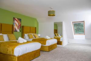 a hotel room with two beds with green walls at Luxury Mansion, Central, Perfect for Groups in Durham