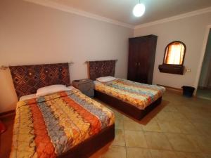 a hotel room with two beds and a window at Arabesque Hotel in Cairo +56 photos