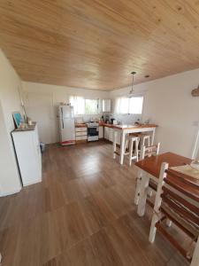 a kitchen and dining room with a table and refrigerator at Casa en Chapa in La Estafeta +9 photos