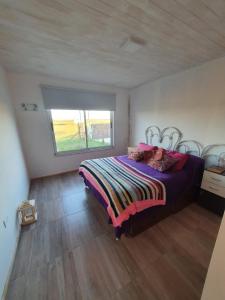 a bedroom with a bed in a room with a window at Casa en Chapa in La Estafeta