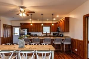 a kitchen with wooden cabinets and tables and chairs at Sound Choice in Edisto Island
