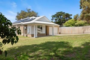 a house with solar panels on the roof at My Happy Place in Rye