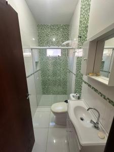 a bathroom with a shower and a toilet and a sink at Barra de Ibiraquera in Barra de Ibiraquera +43 photos