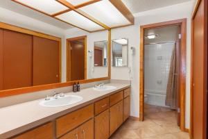 a bathroom with two sinks and a shower at Lenawee 1740 by Summit County Mountain Retreats in Keystone