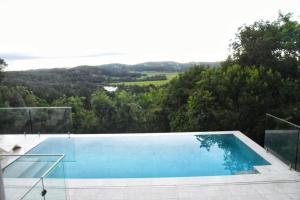a swimming pool on the side of a house at RiverView GetAway in Maroochy River