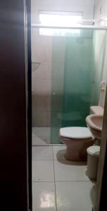 a bathroom with a toilet and a sink at Casa de praia Maçarico in Salinópolis