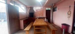 a room with a wooden table in a room at Casa de praia Maçarico in Salinópolis