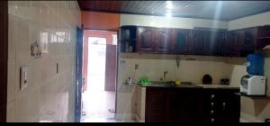 a kitchen with a sink and a counter top at Casa de praia Maçarico in Salinópolis +3 photos