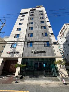 a tall building with a sign on the front of it at Rings Hotel in Gunsan