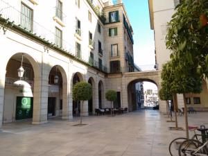 an empty street in a city with buildings at Old Center Inn Alicante in Alicante