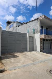 a house with a fence and a garage at Casa Hospedaje Maria Paula in Aguachica +5 photos