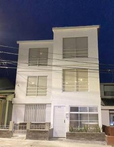 a white house with a white door and windows at Apartamento acogedor cerca al Cable in Manizales