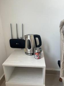a coffeemaker sitting on top of a white table at Apartamento acogedor cerca al Cable in Manizales