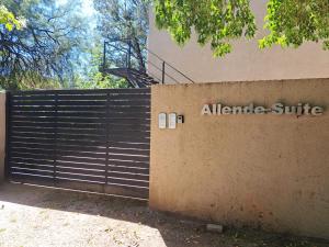 an entrance to an atlantic shuttle sign on a fence at Allende Apart St in Villa Allende