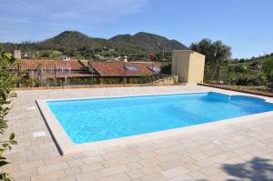 a swimming pool in a yard with a house at Casa Vacanza Cardedu in Cardedu