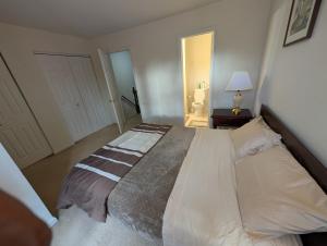a bedroom with a large bed in a room at 3 Bedroom Townhouse 8 Miles to Washington DC in Falls Church