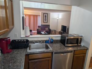 a kitchen with a sink and a microwave at 3 Bedroom Townhouse 8 Miles to Washington DC in Falls Church +14 photos