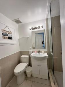 a bathroom with a toilet and a sink and a shower at Riverwood Home in Mississauga +27 photos