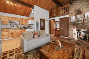 a living room with a couch and a fireplace at The Beary Cozy Cabin, Huge Snow Play Area! in Sugarloaf