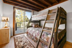 a bedroom with a bunk bed and a large window at The Beary Cozy Cabin, Huge Snow Play Area! in Sugarloaf