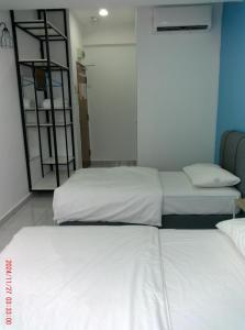 Postel nebo postele na pokoji v ubytování Gemilang Hotel Klang