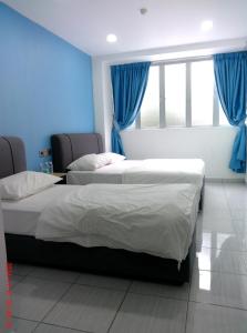 Postel nebo postele na pokoji v ubytování Gemilang Hotel Klang