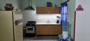 a small kitchen with a sink and a refrigerator at Casa-Rancho Grande in Santa María