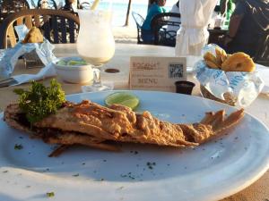 a piece of food on a white plate on a table at Encantador Apartamento con agua caliente in Los Paredones +34 photos