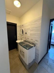 a bathroom with a sink and a stove in it at Adwa Mega City Luxury Apartment in Addis Ababa