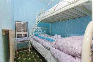 a bedroom with two bunk beds and a mirror at WinterFell On Arbat Hotel in Moscow