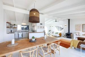 a kitchen and living room with a table and chairs at Rosewood House in Lower Beechmont