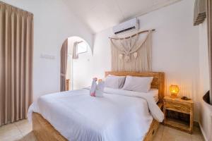 a bedroom with a large white bed with two towels at Private 3BR Villa Bali Work & Relax Retreat near Canggu, Bathtub in Dalung