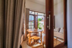 a small table in a room with a window at Private 3BR Villa Bali Work & Relax Retreat near Canggu, Bathtub in Dalung