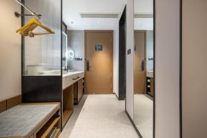 a hallway of a bathroom with a sink at Atour Hotel Chengdu Taikoo Li Silverstone Plaza in Chengdu