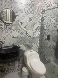 a bathroom with a toilet and a mirror at Parcela Monte Alto Galería in Los Santos +21 photos