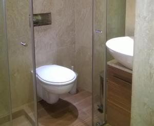 a bathroom with a toilet and a sink at Parkview Apartments in Sofia