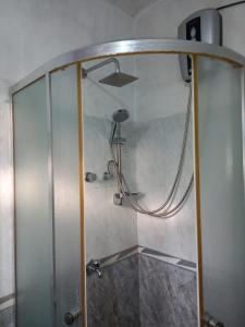 米瑞莎Indika Family Villa的浴室里有玻璃门的淋浴间