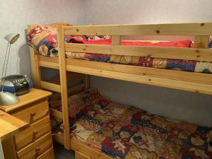 a bedroom with two bunk beds and a desk at Charmant Appartement à Cauterets - Confort et Accueil Chaleureux - FR-1-812-101 in Cauterets +4 photos